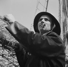 A New England fisherman preparing his boat to leave the New York docks, , New York, 1943. Creator: Gordon Parks.