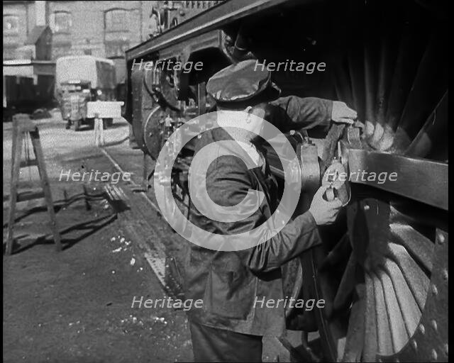 A Man Doing Maintenance Work on a Train Carriage, 1940. Creator: British Pathe Ltd.