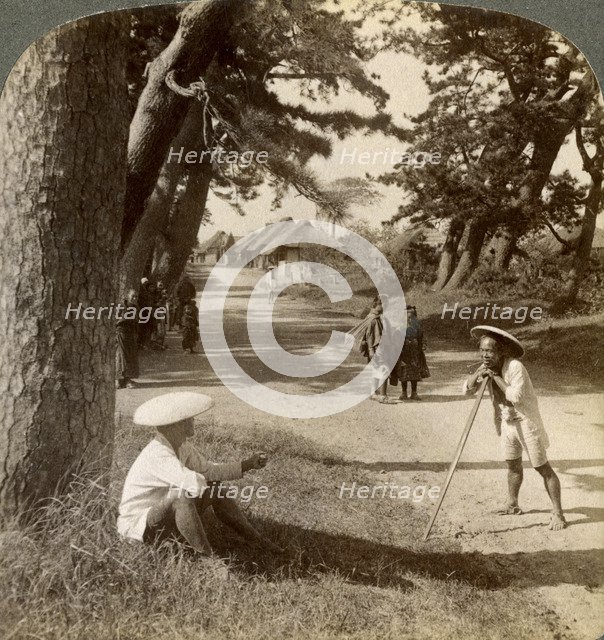 Travellers resting under the pines at Suzukawa, old post road from Tokyo to Kyoto, Japan, 1904.Artist: Underwood & Underwood
