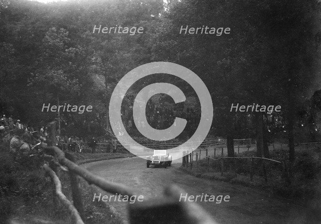 Raymond Mays' 4500 cc Invicta competing in the Shelsley Walsh Speed Hill Climb, Worcestershire. Artist: Bill Brunell.