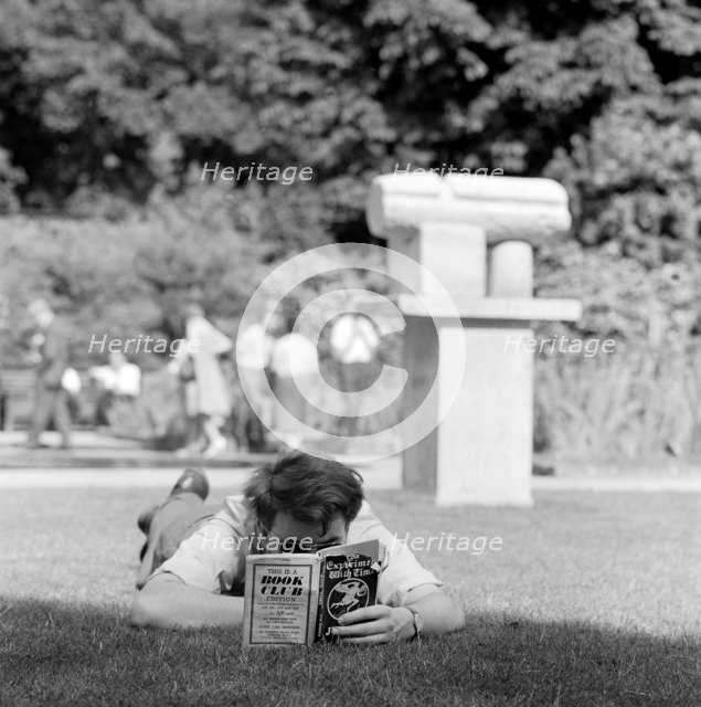 Man reading in a park, London, 1962-1964. Artist: John Gay