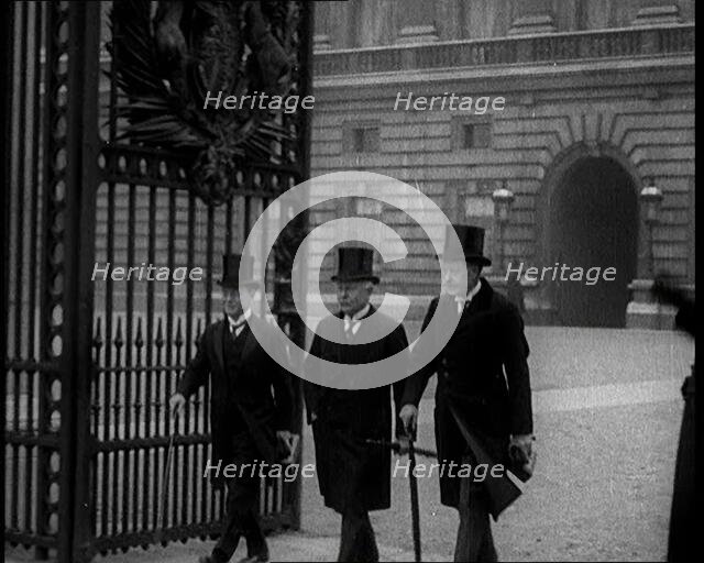 Three Male British Members of Parliament Walking Away from Buckingham Palace, Passing..., 1924. Creator: British Pathe Ltd.