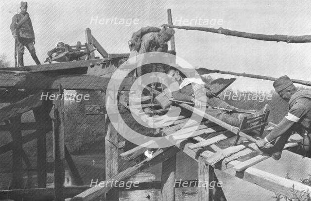 'La Retraite Serbie; Evacuation des blesses sur la rive droite de la Morava, par un pont de..., 1916 Creator: Vladimir Betzitch.