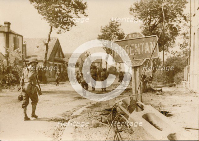 Allied troops moving throught the village of Argentan, France, 1944. Artist: Unknown
