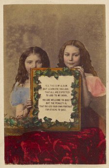 Two unidentified girls holding a framed picture with text, 1870-1875. Creator: Burgwitz & Company.