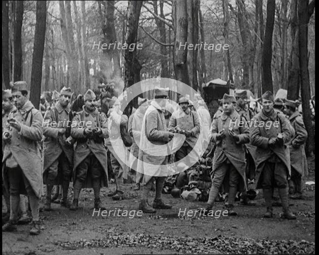 Male French Soldier Stand in a Wood Eating, 1924. Creator: British Pathe Ltd.