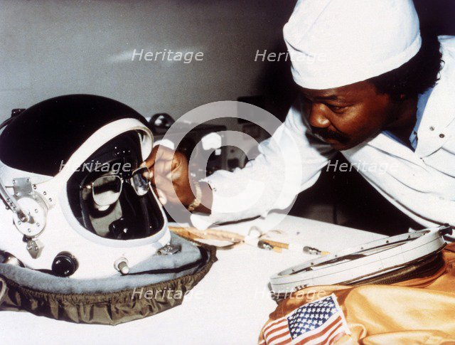 Technician installing eye-glasses in helmet. Creator: NASA.