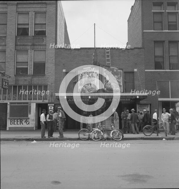 Idle men attend the morning movies, Oklahoma City, Oklahoma, 1937. Creator: Dorothea Lange.