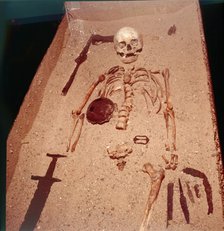 Viking Burial of Man with Axe, Spear, Sword , Knives, Shield and Belt Buckle, 9th-10th century. Artist: Unknown.