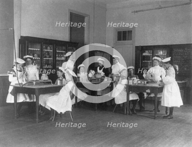 Classroom scene in Washington, D.C. elementary school - cooking class, (1899?). Creator: Frances Benjamin Johnston.