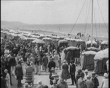 Civilians Enjoying a Sunny day on a Very Crowded Beach, 1920. Creator: British Pathe Ltd.