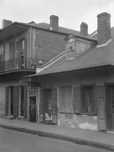 View from across street of two children standing in a doorway in the French Quarter..., c1920-1926. Creator: Arnold Genthe.