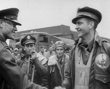 A Male Pilot Shaking Hands with an Officer, whilst other Pilots are Looking On, 1943-1944. Creator: British Pathe Ltd.