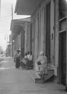 View down a sidewalk, New Orleans, between 1920 and 1926. Creator: Arnold Genthe.