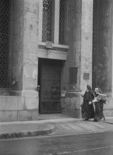 Sisters of Charity and the gateway of the Armory, New Orleans, between 1920 and 1926. Creator: Arnold Genthe.