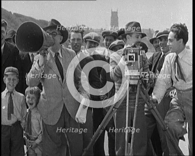 A Group of People Laughing as They Are Watch the Film Being Made from Behind a Camera, 1920s. Creator: British Pathe Ltd.
