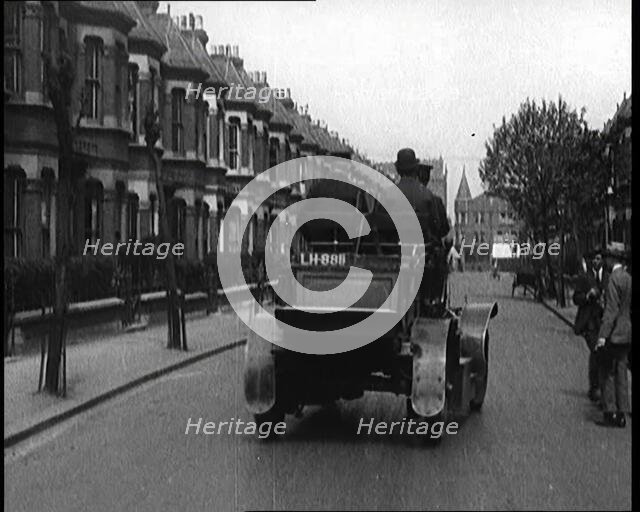 Fire Engine Driving Down the Street, 1920. Creator: British Pathe Ltd.