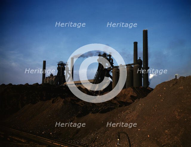 Iron ore piles and blast furnaces, Carnegie-Illinois Steel Corporation mill, Etna, Pa., 1941. Creator: Alfred T Palmer.