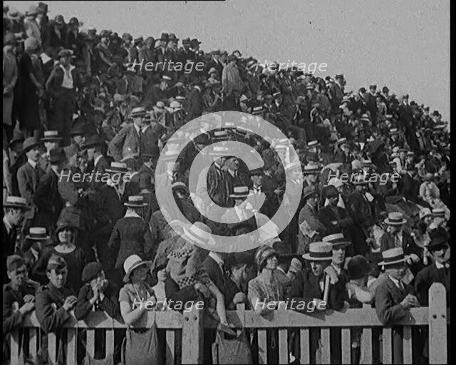 A Group of People Waving As Old Fashioned Looking Hot Air Balloons Are Taking Off the Ground, 1920s. Creator: British Pathe Ltd.