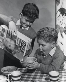 Two boys having a bowl of Quiz Corn Flakes, c1955.  Creator: Arthur Charles Kirby Ware.
