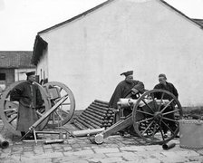 Nanking, Kiangsu province, China: three men examining a gun at the arsenal, 1871. Creator: John Thomson.