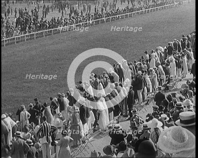 A Large Crowd of Civilians Watching a Horse Race, 1920. Creator: British Pathe Ltd.