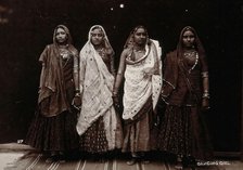 A troupe of nautch dancing girls, standing in a line holding hands, in a studio setting, c1900. Creator: Unknown.