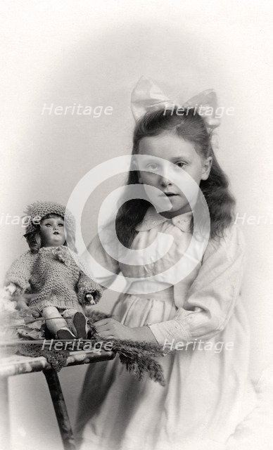 A young girl holding a doll, 20th century. Artist: Unknown
