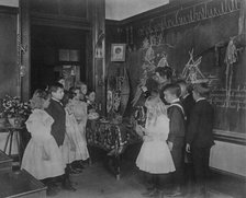 Teacher showing students Native American handicrafts at a school in Washington, D.C., (1899?). Creator: Frances Benjamin Johnston.