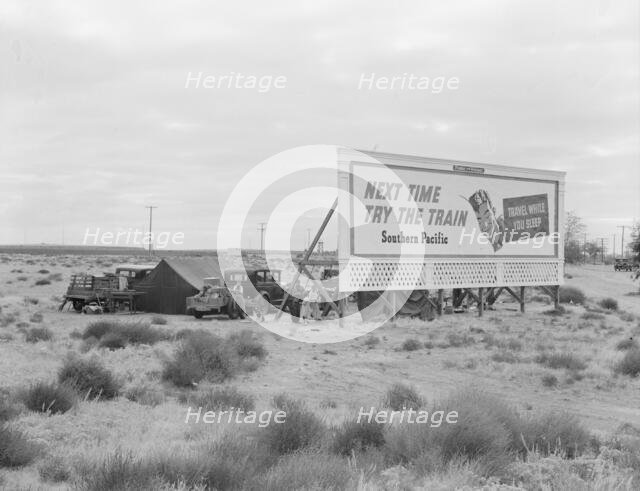 Billboard along U.S. 99...three destitute families...Kern County, CA, 1938. Creator: Dorothea Lange.