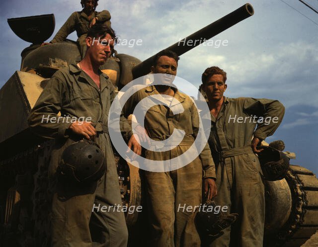 Tank crew standing in front of an M-4 tank, Ft. Knox, Ky., 1942. Creator: Alfred T Palmer.
