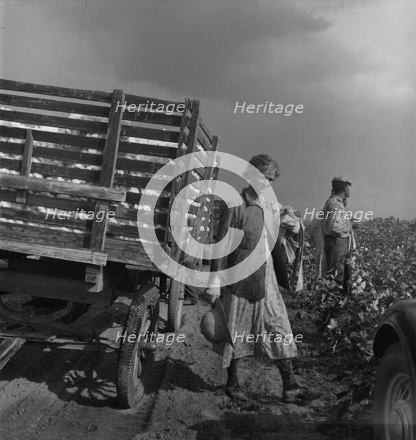 Migratory cotton pickers have stopped working because it started to rain, Kern County, CA, 1938. Creator: Dorothea Lange.