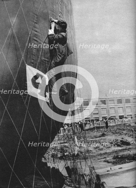 Making adjustments to the net of a balloon before attaching the basket, c1935 (c1937). Artist: Unknown.