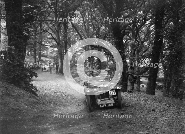 MG Magna competing in the B&HMC Brighton-Beer Trial, Fingle Bridge Hill, Devon, 1934. Artist: Bill Brunell.