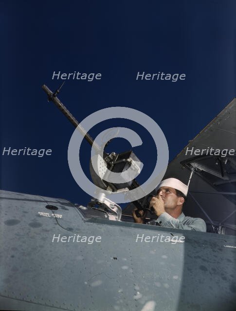 He's like to use that gun on the Axis, Naval Air Base, Corpus Christi, Texas, 1942. Creator: Howard Hollem.