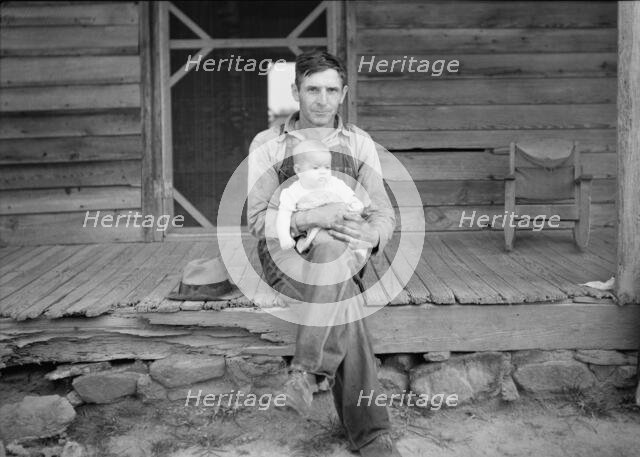 Mr. Whitfield, tobacco sharecropper with baby..., North Carolina, Person County, 1939. Creator: Dorothea Lange.
