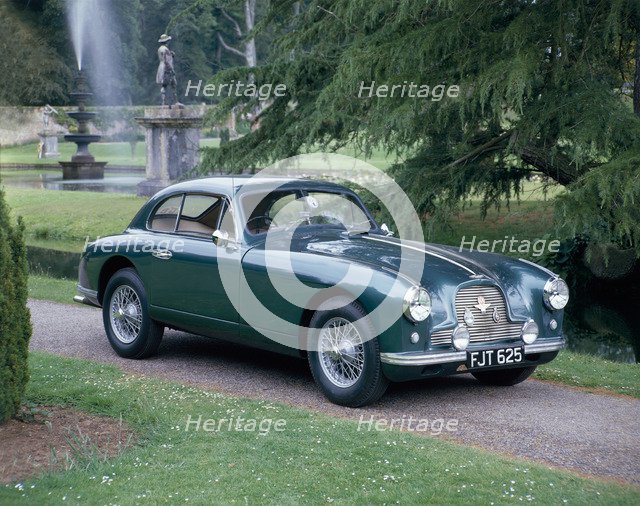 A 1952 Aston Martin DB2 saloon car photographed in a stately garden. Artist: Unknown