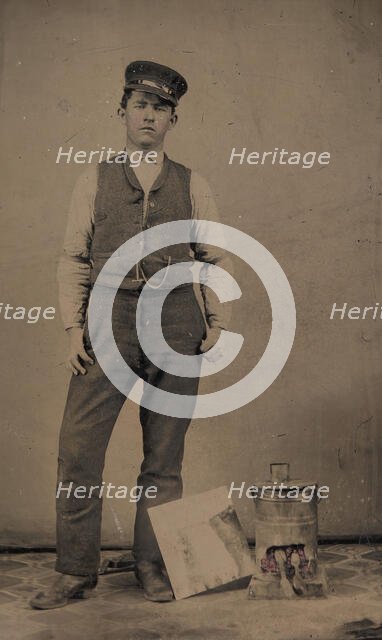Tinsmith with Coal Heater and Sheet of Tin, 1870s-80s. Creator: Unknown.