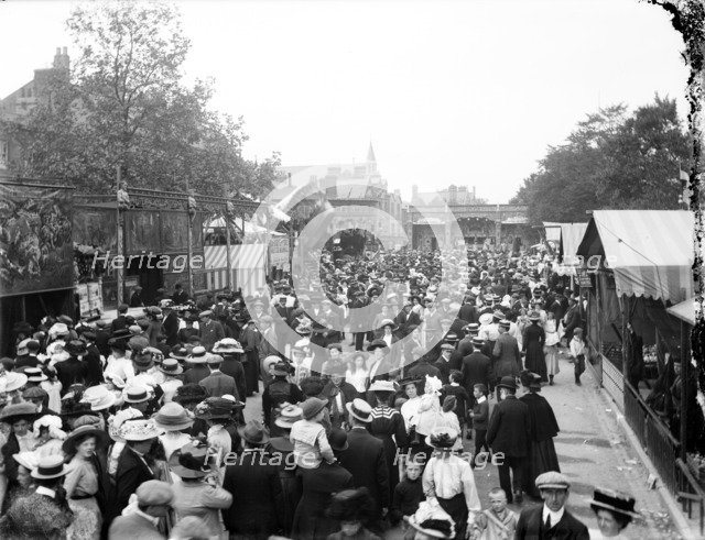 Crowded street lined with stalls during St Giles Fair, Oxford, Oxfordshire, c1860-c1922. Artist: Henry Taunt