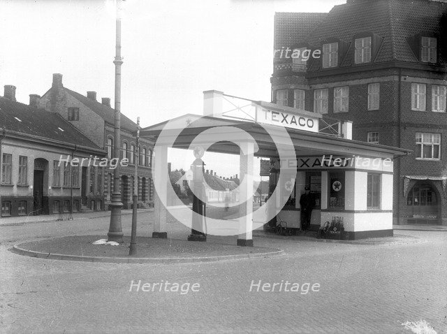 A  Texaco petrol pump in a built-up area, Landskrona, Sweden, 1930 Artist: Unknown