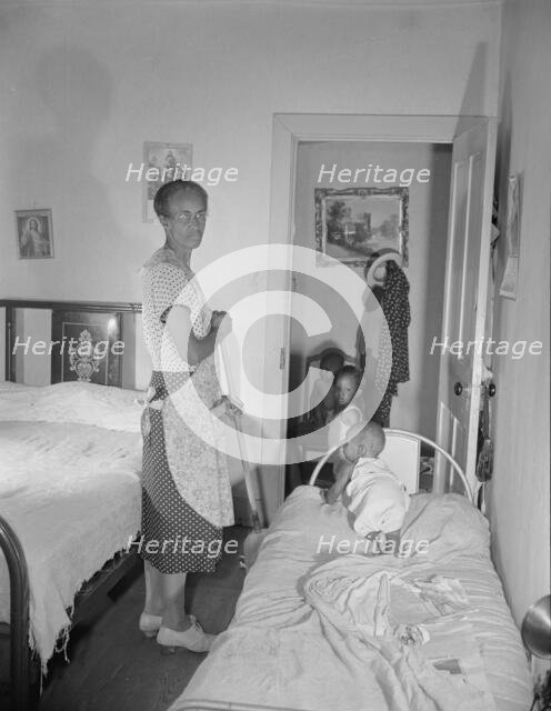 Grandchild of Mrs. Ella Watson, a government charwoman, taking her...nap, Washington, D.C, 1942. Creator: Gordon Parks.