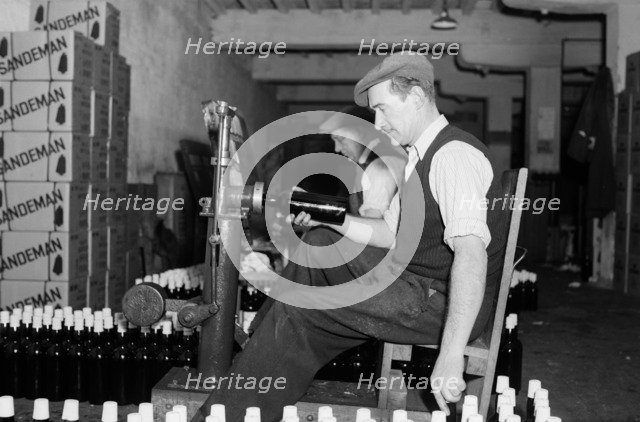 Sealing bottles of port wine at the Cutler Street warehouses, London, c1945-1965. Artist: SW Rawlings