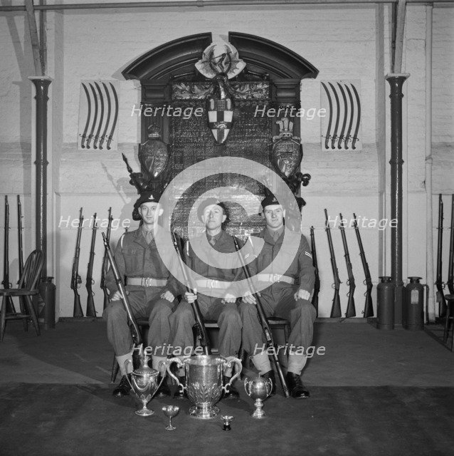 Three soldiers are posed in front of the Honourable Artillery Company's war memorial, c1945-c1965. Artist: SW Rawlings