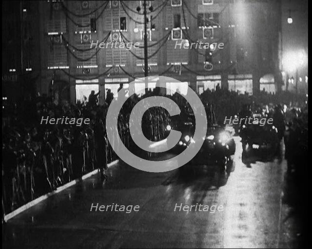 A Nazi Party Motorcade Driving Down a Berlin Street Lined With Crowds..., 1937. Creator: British Pathe Ltd.