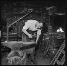Blacksmith working at an anvil, 1967. Creator: Eileen Deste.