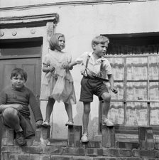 Children playing on a wall, London, 1960-1965. Artist: John Gay
