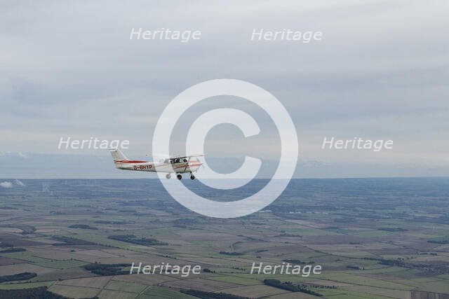 Reims-Cessna F172M Skyhawk in flight near Driffield, East Riding of Yorkshire, 2023. Creator: Chloe Pearson Jones.