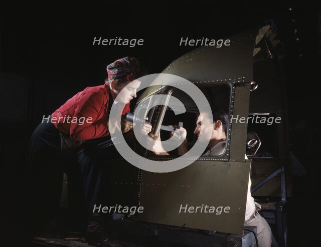 Riveting team working on the cockpit shell of a...Douglas Aircraft Co., Long Beach, Calif. , 1942. Creator: Alfred T Palmer.