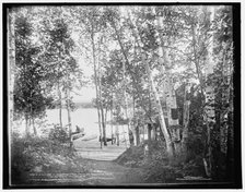 A glimpse of Raquette Lake from St. Hubert's Isle, Adirondack Mountains, c1902. Creator: William H. Jackson.