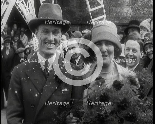 Male Civilian (Groom) And Female Civilian (Bride) Emerging from a Church To Walk Through an...,1920s Creator: British Pathe Ltd.